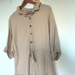 Linen romper in a neutral tone . Beige color .
